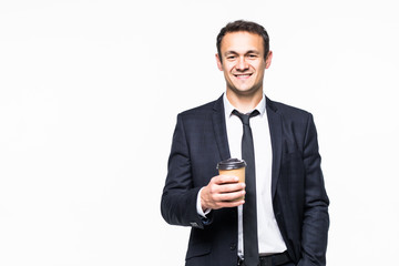 Naklejka premium Happy young businessman holding cup of coffee over gray background