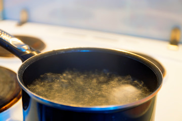 History of making a quick Breakfast. Chicken eggs are cooked in a pan on the stove. Moscow, Russia.