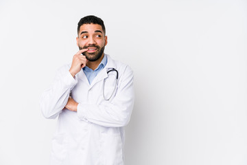 Young arabian doctor man isolated relaxed thinking about something looking at a copy space.