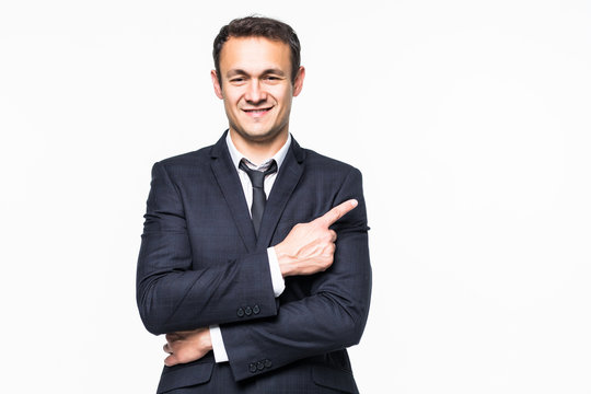 Handsome young business man pointing to his right side isolated on white background