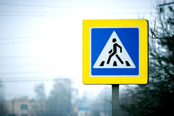 Pedestrian crossing sign on the side of the road. Road safety_