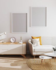 Two blank poster frames in modern living room interior background. Mockup, living room with white wall and modern minimalistic furniture. Scandinavian style, stylish living room interior. 3d render