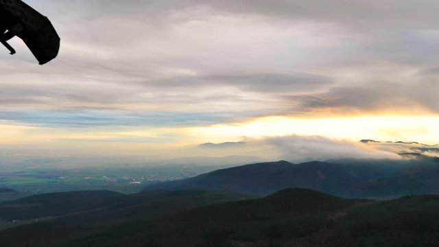 Canal&oacute;n de castillo frente a paisaje de atardecer con maravillosos rayos solares azules y naranjas