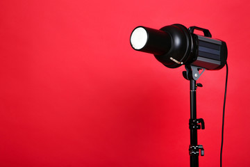Studio lighting with tripod on red background