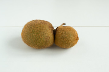 Ugly fruits. Fancy Kiwi on a white background. Horizontal orientation