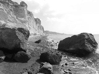 Fototapeta premium Landscape with cliffs and large stones on the coast near Akrotiri. Santorini, Greece.