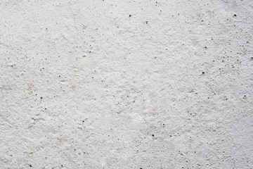 White concrete wall. Porous texture.