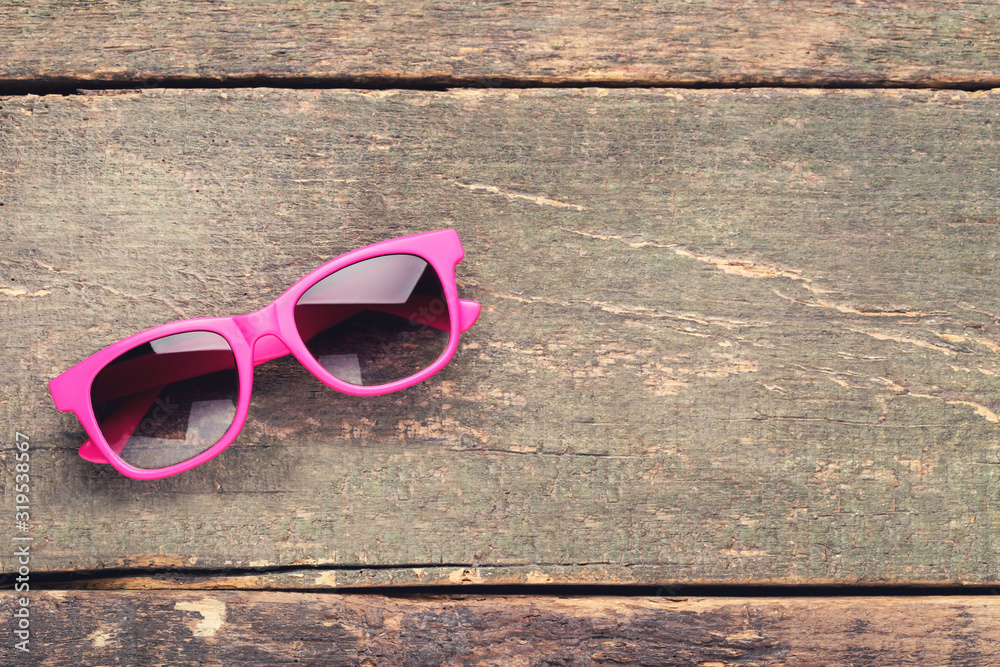 Wall mural fashion sunglasses on grey wooden table