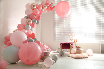 Room decorated with colorful balloons for party