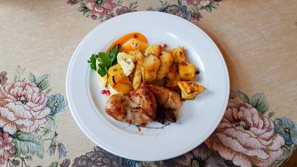 Small pieces of chicken and fried potatoes served for lunch