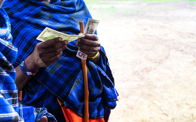 African man counting money, counting dollars.