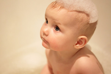 little girl bathes in a bath