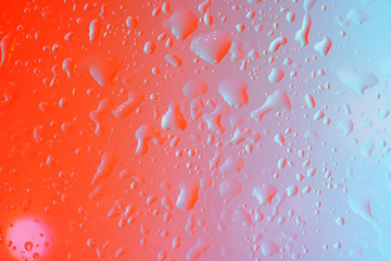 Drops of water on a glass sheet with flashes and color film Photographed in the studio