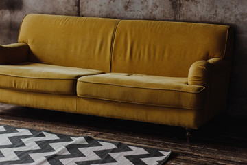 Yellow velvet couch in loft room