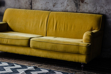 Yellow velvet couch in loft room
