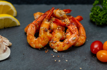 mouth watering beautiful fresh shrimps with vegetables on a stone tray