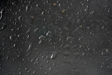 Drops of water on a glass sheet with flashes and color film Photographed in the studio