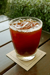 Vertical Image of a Glass of Iced Coffee on Wooden Table