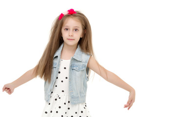 A cheerful little girl is dancing.