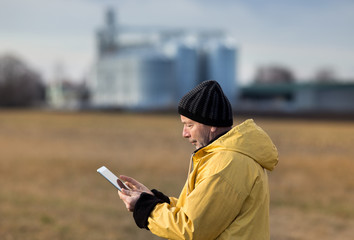 Farmer with tablet in field