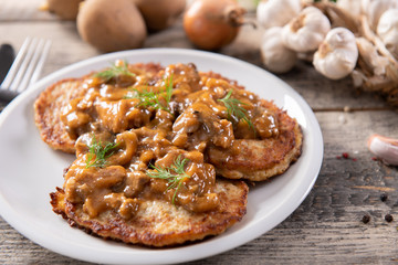 Tasty homemade potato pancakes with meat and mushrooms