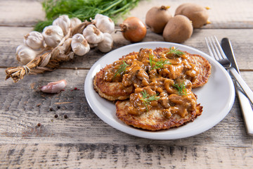 Tasty homemade potato pancakes with meat and mushrooms