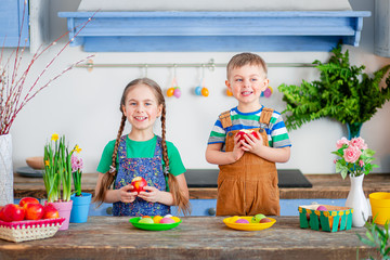 Happy easter. Cute brother and sister, funny kids boy and girl are preparing for the holiday.