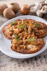 Tasty homemade potato pancakes with meat and mushrooms