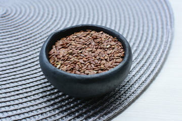  natural flaxseed seeds displayed in containers