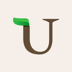 Ecology U serif letter logo with green leaf.
