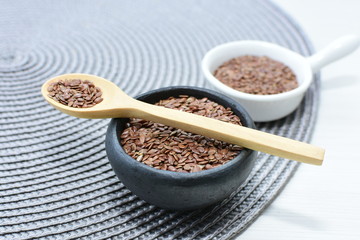  natural flaxseed seeds displayed in containers