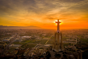 statue of Jesus Christ against the rays of the setting sun