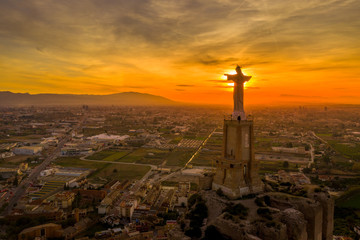 Jesus christ statue against the setting sun light