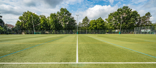 Panoramic view of football field stadium. Natural green grass. Wide angle lens shot