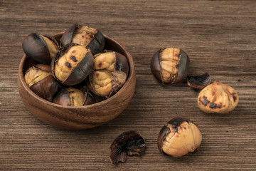 roasted chestnuts in a bowl on a wooden table