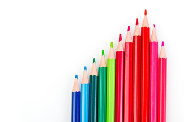 macro multicolored pencils on a white background