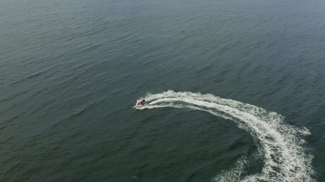 Aerial view of a motor boat sailing near the beach