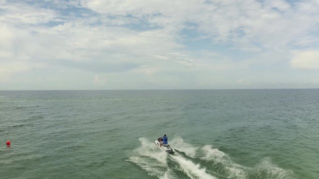 Aerial view of a motor boat sailing near the beach