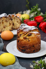 Easter cake Cruffin and colorful eggs on a dark background, The concept of the spring orthodox church holiday, Vertical orientation