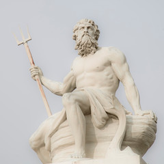 Close up mighty god of sea and oceans Neptune (Poseidon) against blue sky background. The ancient...