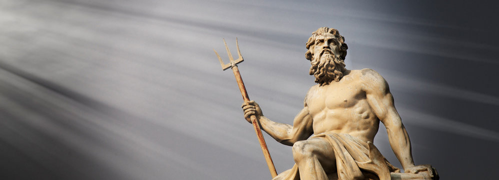 The mighty god of sea and oceans Neptune (Poseidon) against blue sky background. The ancient statue.