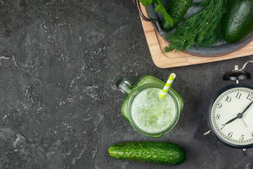 Flatlay on a black background. Green cucumber smoothie. Healthy breakfast. Vegetarian drink with avocado.