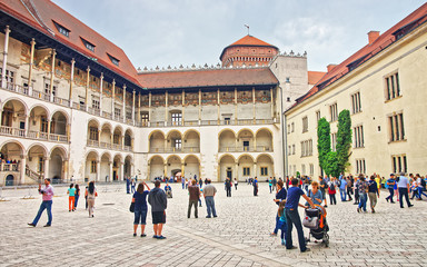 Obraz premium Krakow, Poland - May 1, 2014: People at inner courtyard of Wawel Castle, Krakow, Poland