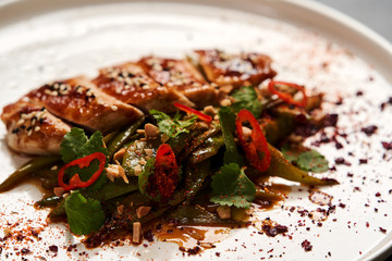 Spicy chicken breast with minted green beans, close-up