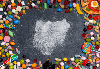 Sugar in the shape of Nigeria surrounded by a variety of sweets. (series)