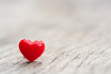 Fototapeta premium Valentines Day concept - Red hearts on plank wooden background with copy space.