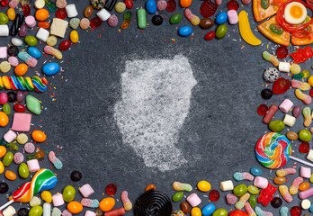 Sugar in the shape of Sudan surrounded by a variety of sweets. (series)
