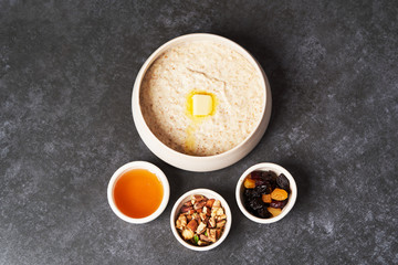 Obraz na płótnie Canvas Healthy breakfast - milk rice porridge in a white plate on grey table background