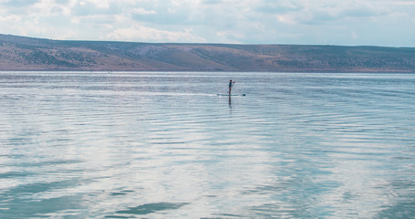 young woman SUP boarding