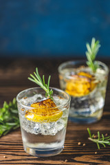 Charred Lemon, Rosemary and Coriander Gin and Tonic is a flavors are perfectly balanced refreshing cocktail. on dark background, close up.